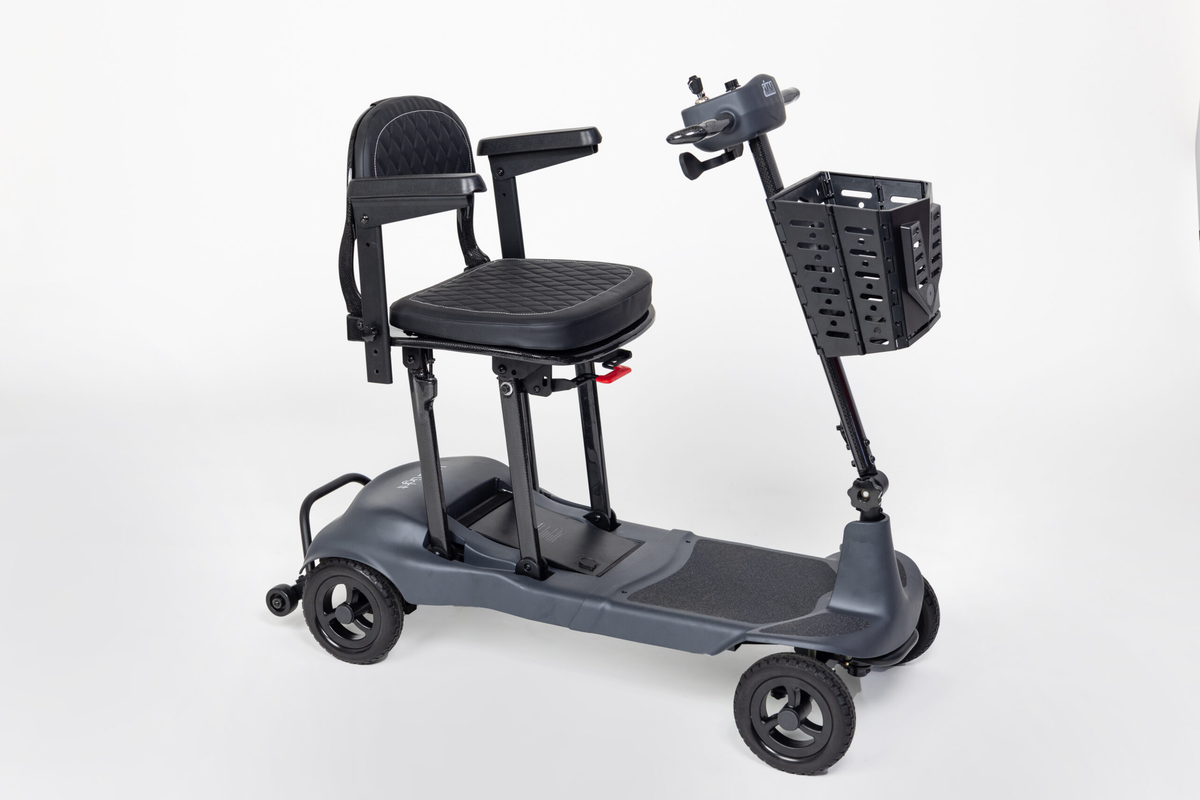 Grey Monarch Mobility Genie Ultralight folding mobility scooter with padded seat, armrests, and front basket.