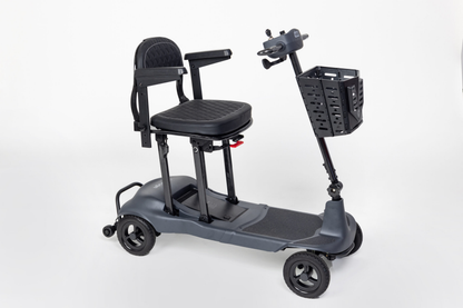 Grey Monarch Mobility Genie Ultralight folding mobility scooter with padded seat, armrests, and front basket.