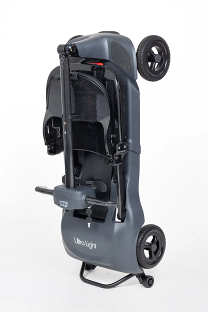Grey Monarch Mobility Genie Ultralight scooter folded upright for storage and transport.