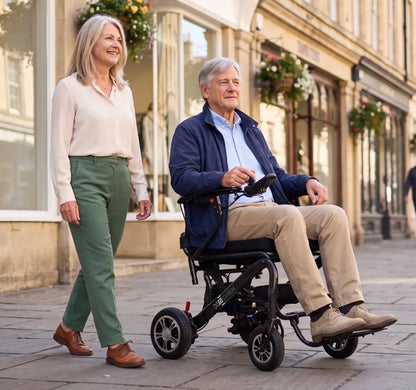 Man using Monarch MM60 lightweight electric wheelchair while traveling outdoors