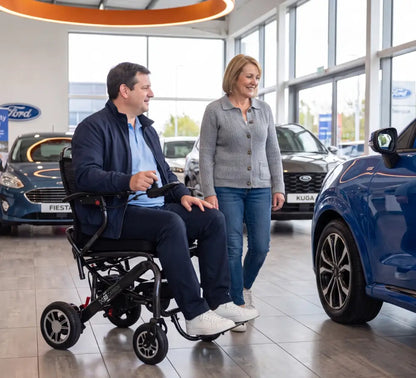 Man using Monarch MM60 lightweight electric wheelchair while shopping for a vehicle