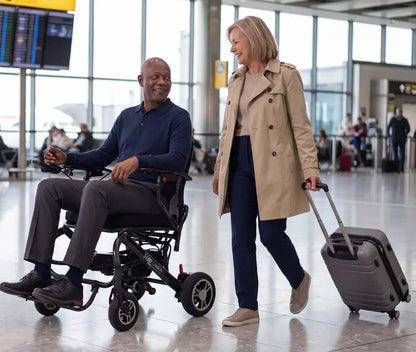 Man using Monarch MM60 lightweight electric wheelchair while shopping for a vehicle
